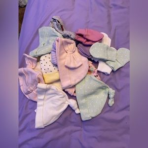 Assortment of baby hats and gloves